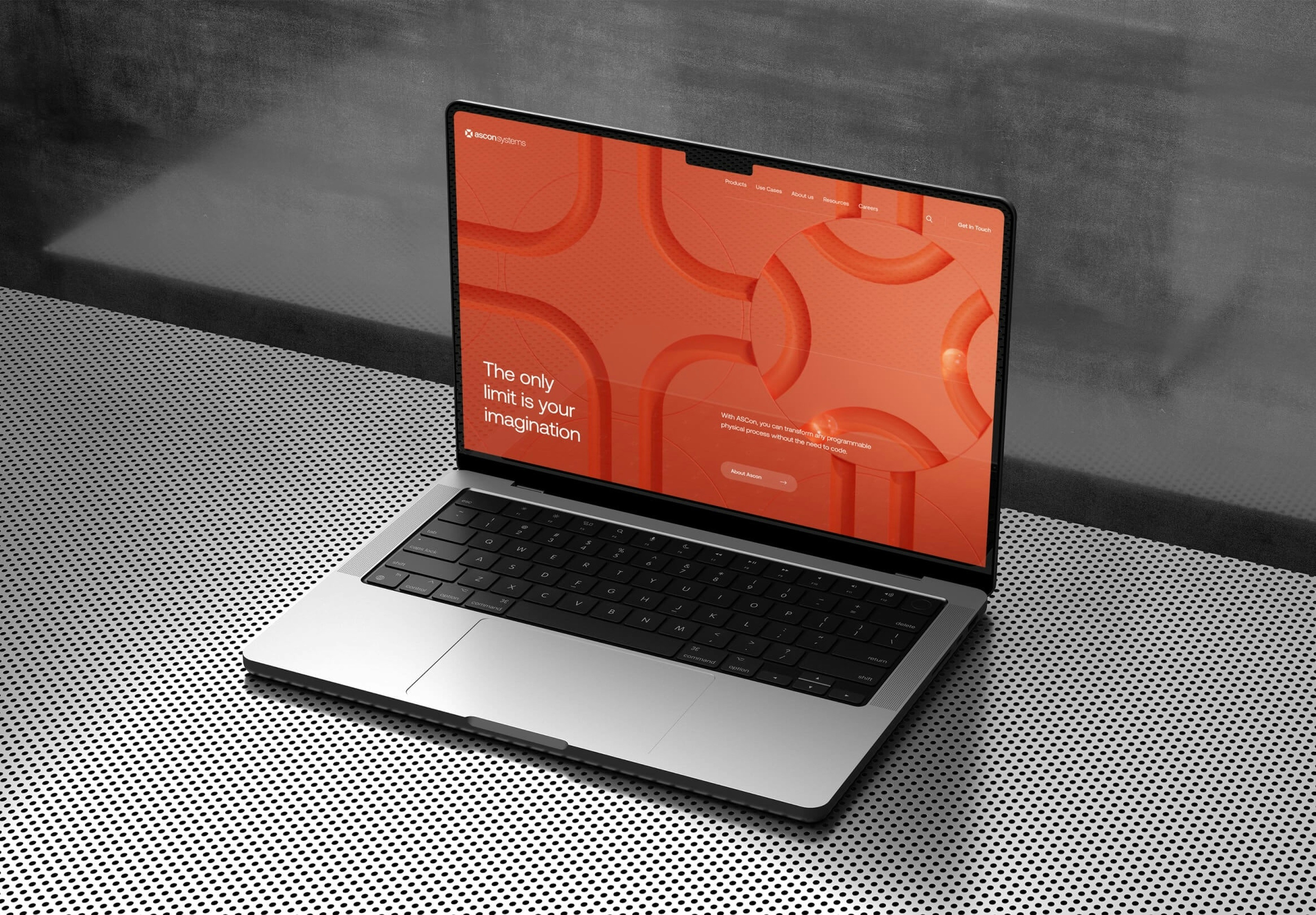 A sleek laptop with a vibrant red patterned screen sits open on a smooth, dark surface.